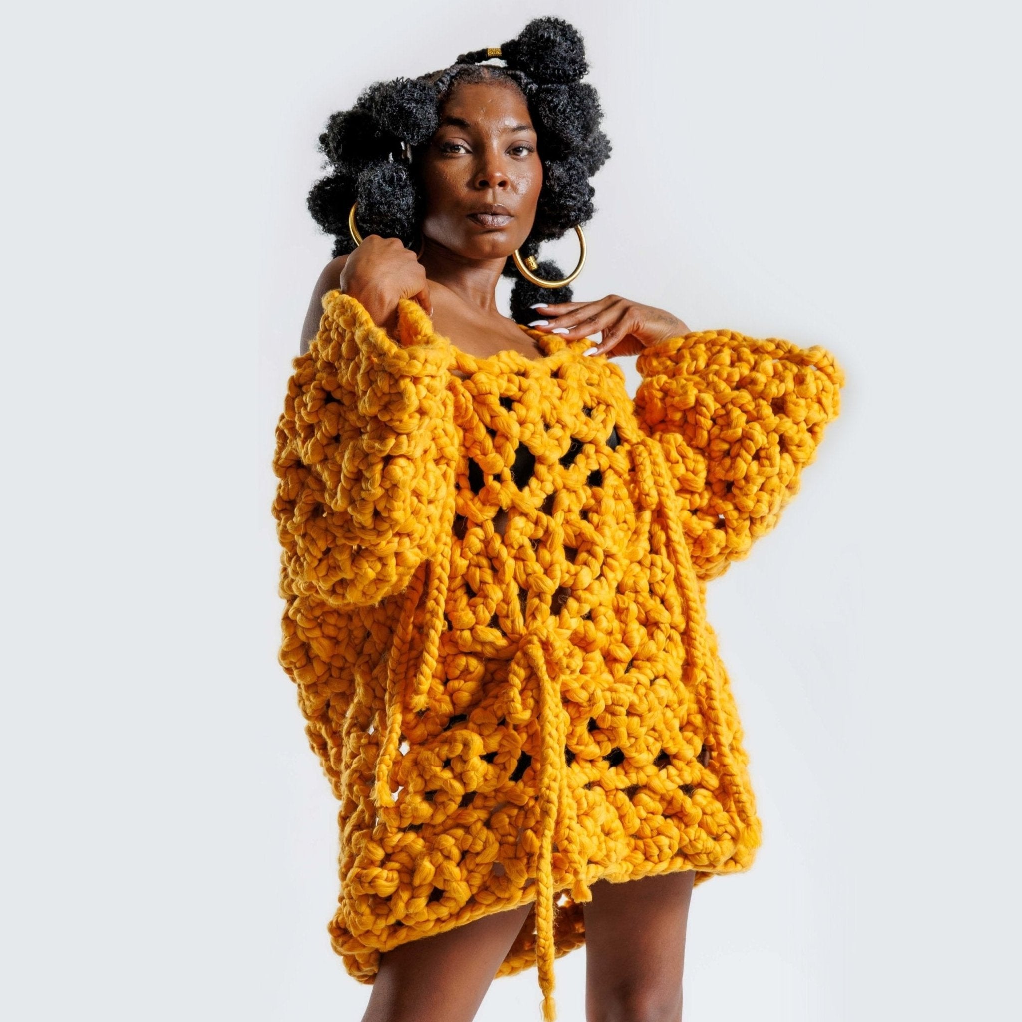 Shone statement knitwear jumper sweater dress. Cosy oversized, chunky colossal knit sweater, with bows, knitted with super soft vegan and sustainable yarn in yellow.