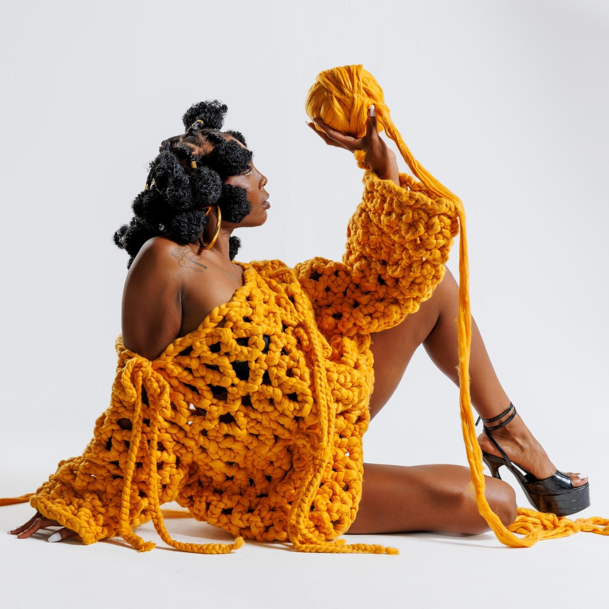 Shone statement knitwear jumper sweater dress. Cosy oversized, chunky colossal knit sweater, with bows, knitted with super soft vegan and sustainable yarn in yellow.