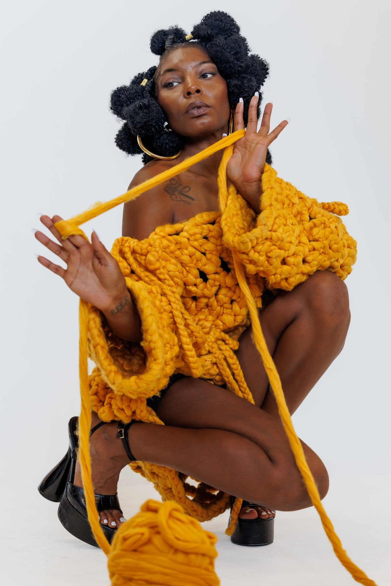 Shone statement knitwear jumper sweater dress. Cosy oversized, chunky colossal knit sweater, with bows, knitted with super soft vegan and sustainable yarn in yellow.