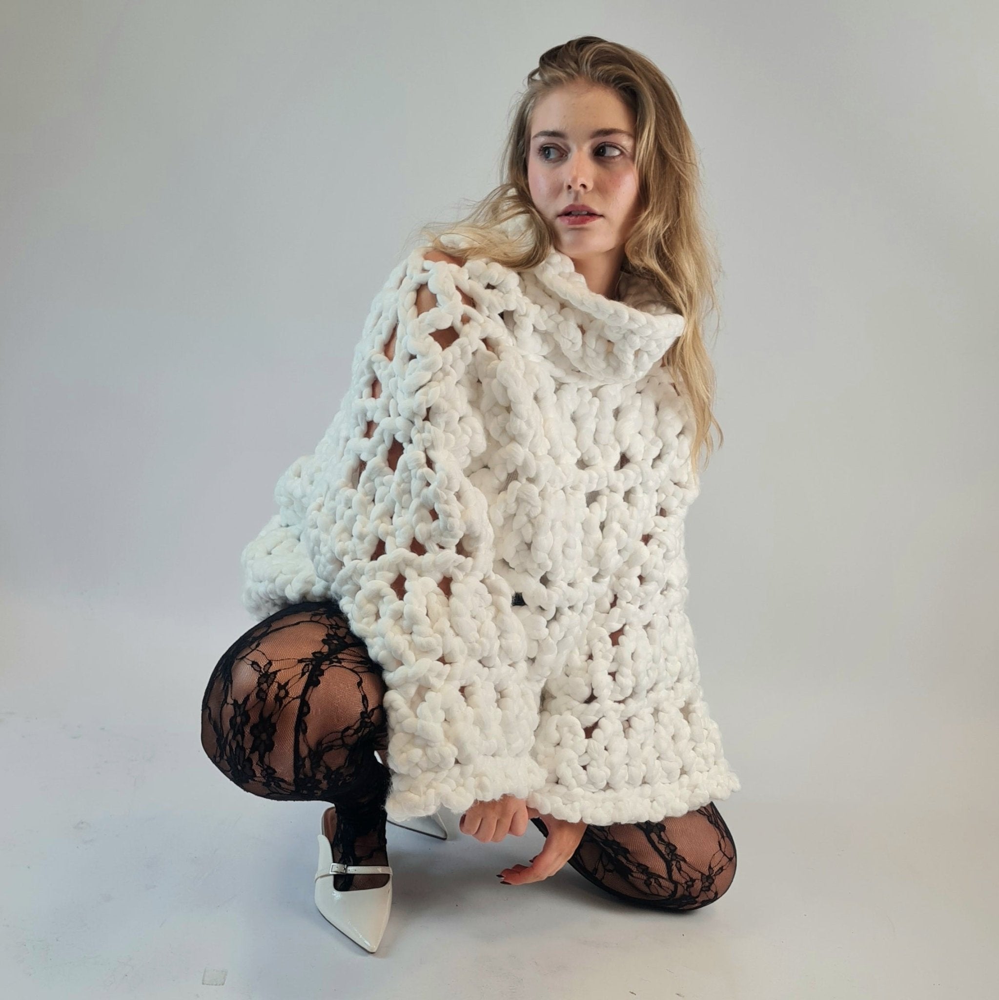 Shone statement knitwear. White oversized, chunky colossal knit sweater, turtle neck design knitted with super soft vegan and sustainable yarn.