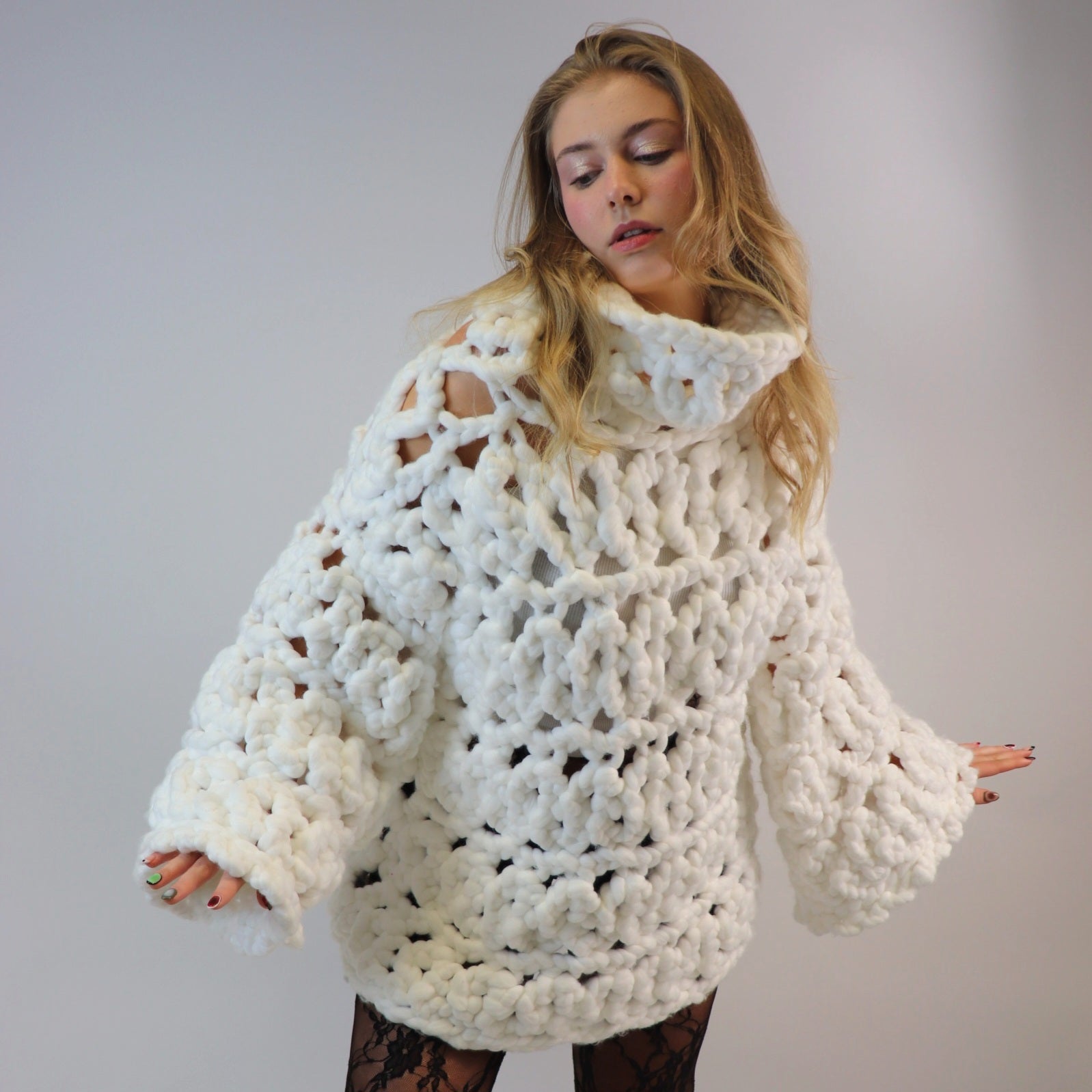 Shone statement knitwear. White oversized, chunky colossal knit sweater, turtle neck design knitted with super soft vegan and sustainable yarn.